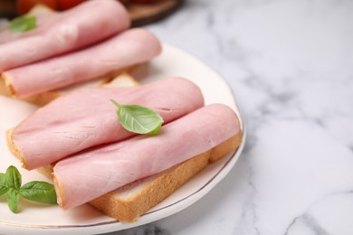 Photo of Delicious sandwiches with ham on white table, closeup