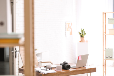 Photo of Modern journalist's workplace with laptop in office