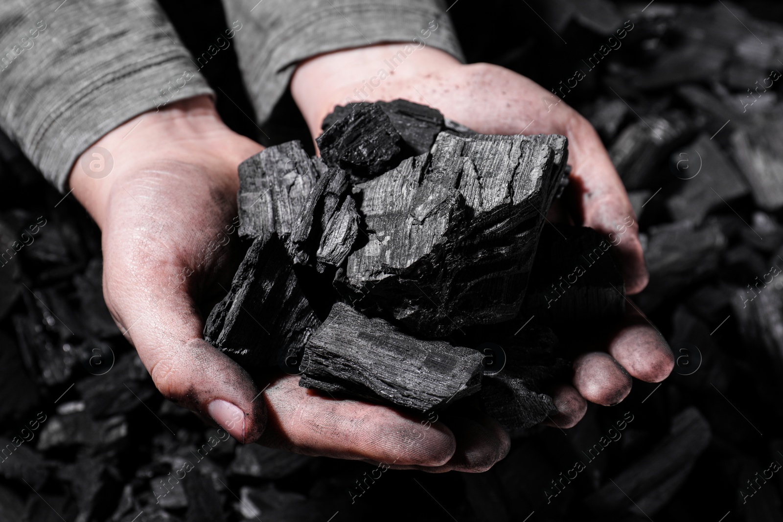 Photo of Man with handful of coal, closeup view