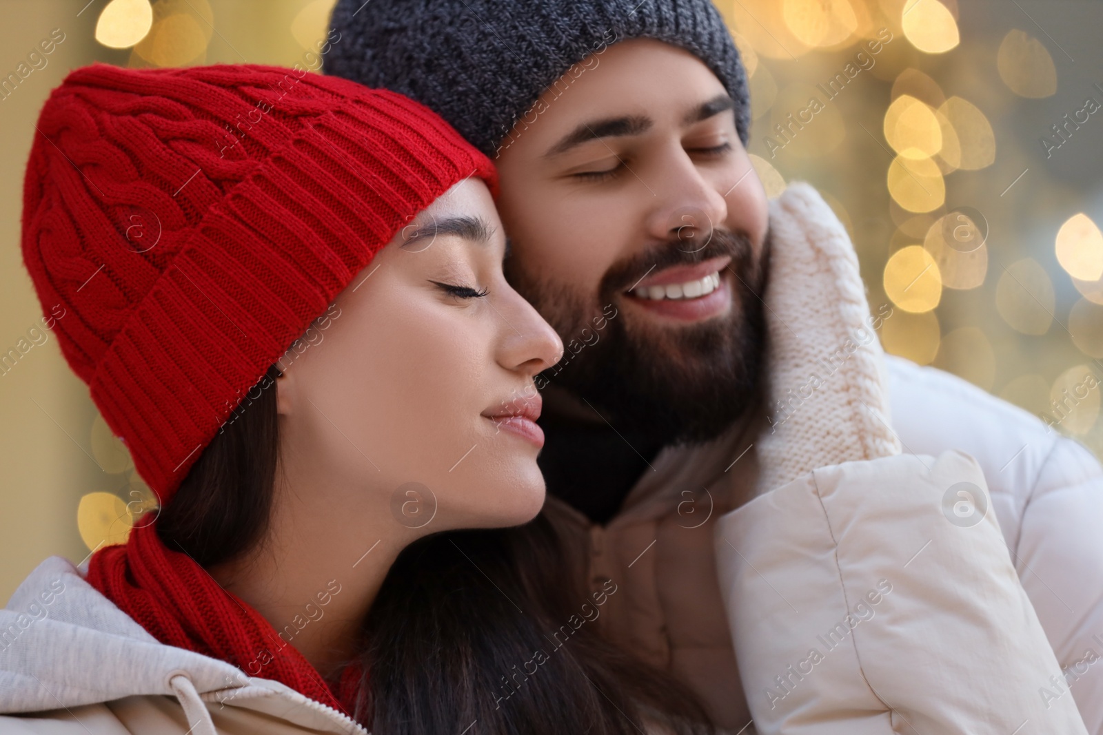 Photo of Portrait of lovely couple outdoors against blurred lights outdoors