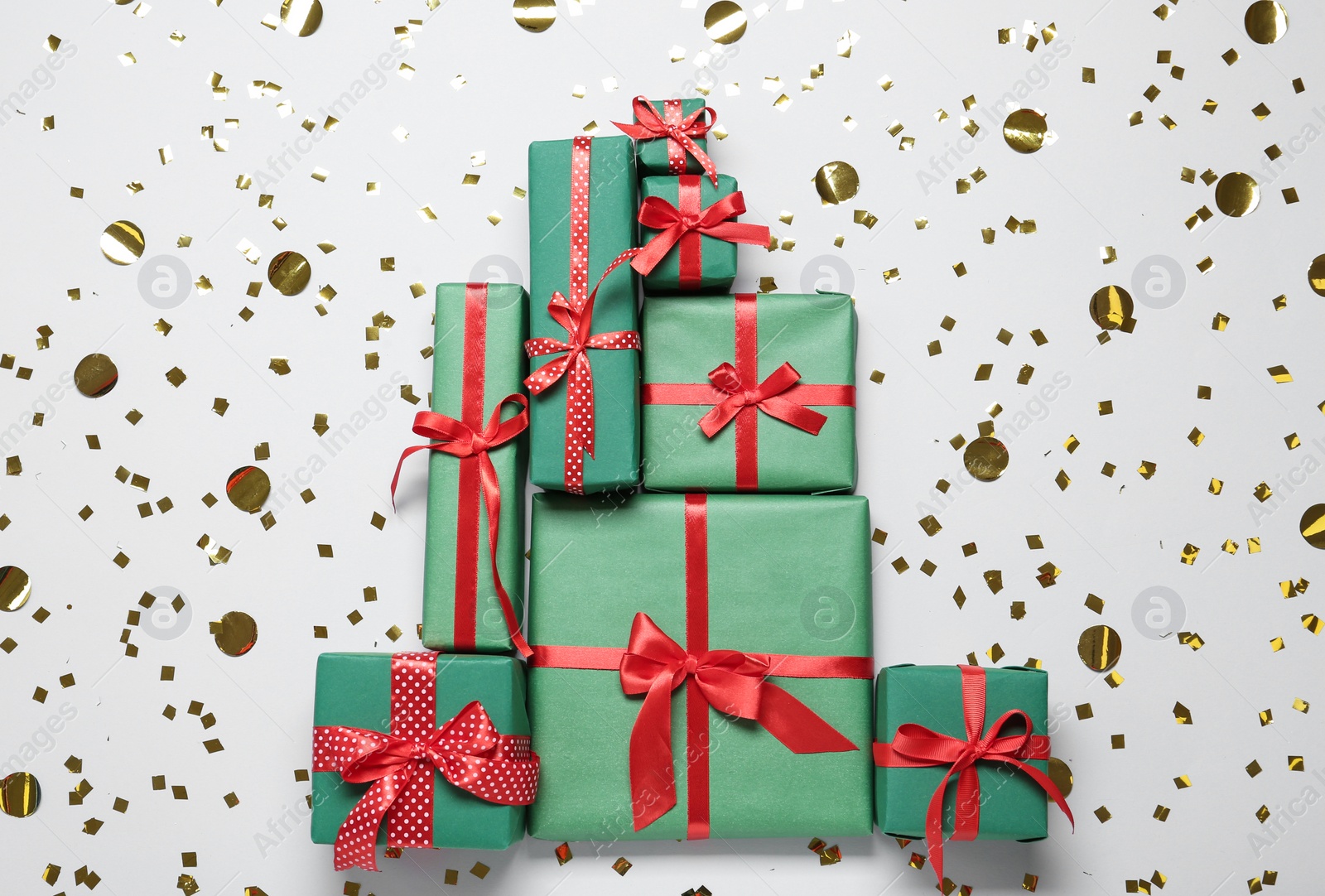 Photo of Christmas tree made with different gift boxes on white background, flat lay