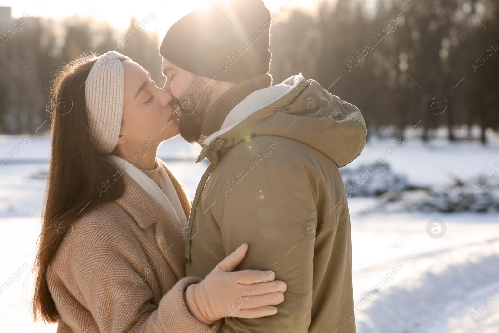 Photo of Beautiful happy couple in snowy park on winter day