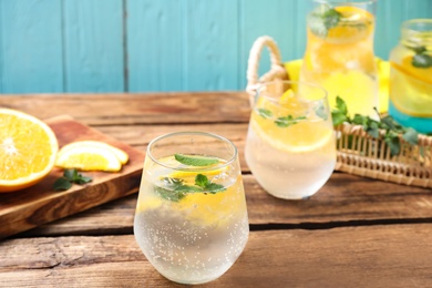 Delicious refreshing citrus drink on wooden table