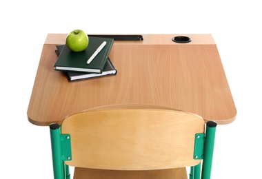 Wooden school desk with stationery and apple on white background