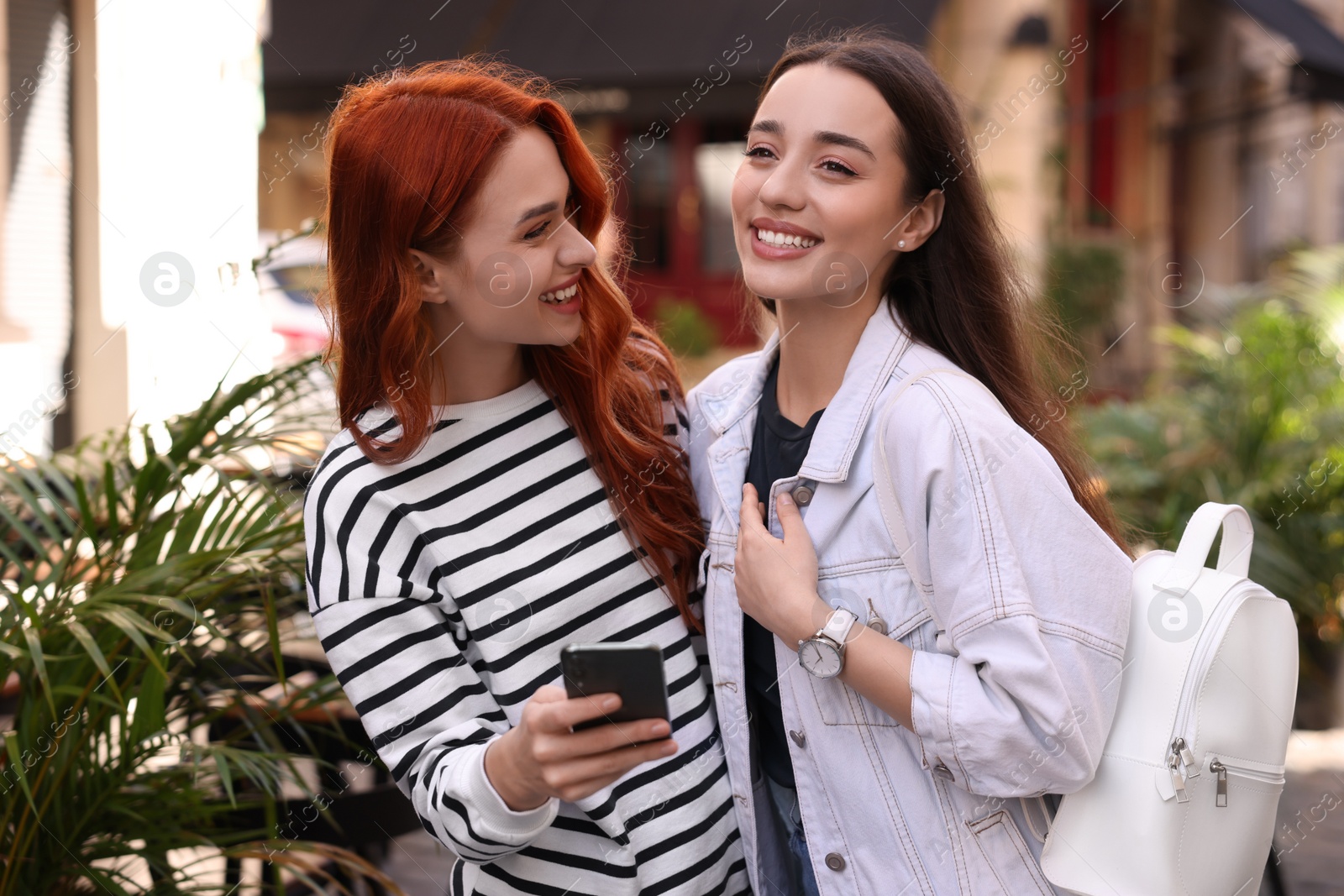 Photo of Happy friends spending time together outdoors on autumn day