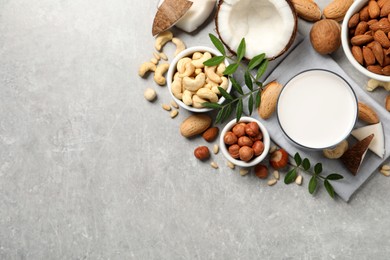 Photo of Vegan milk and different nuts on light table, flat lay. Space for text