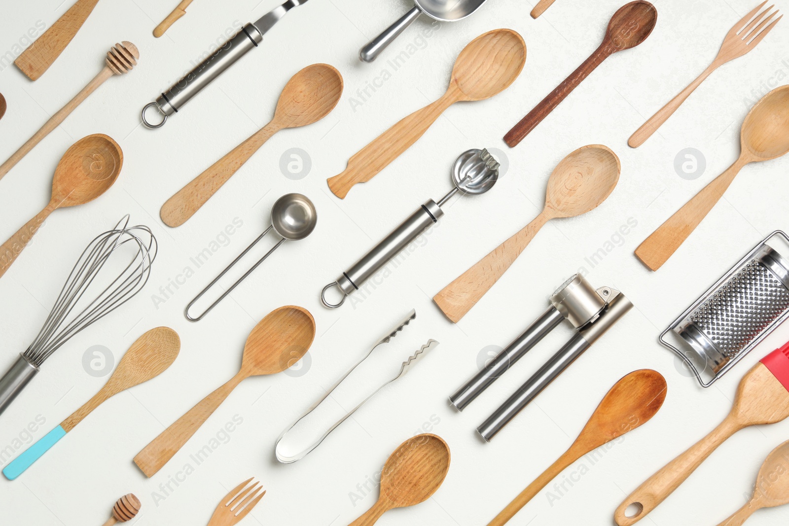 Photo of Set of cooking utensils on white background, flat lay