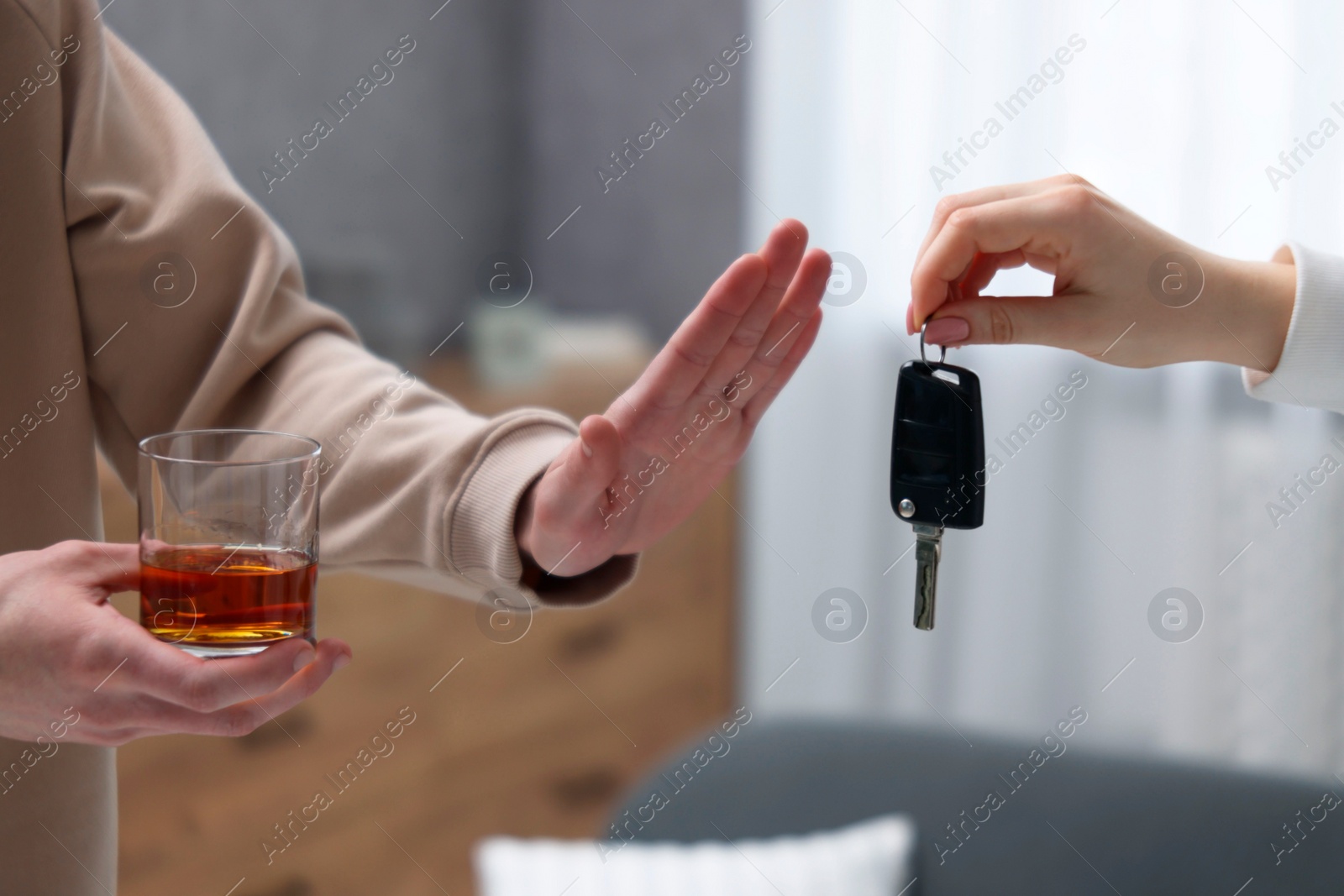 Photo of Drunk man refusing drive car while woman suggesting him keys, closeup. Don't drink and drive concept