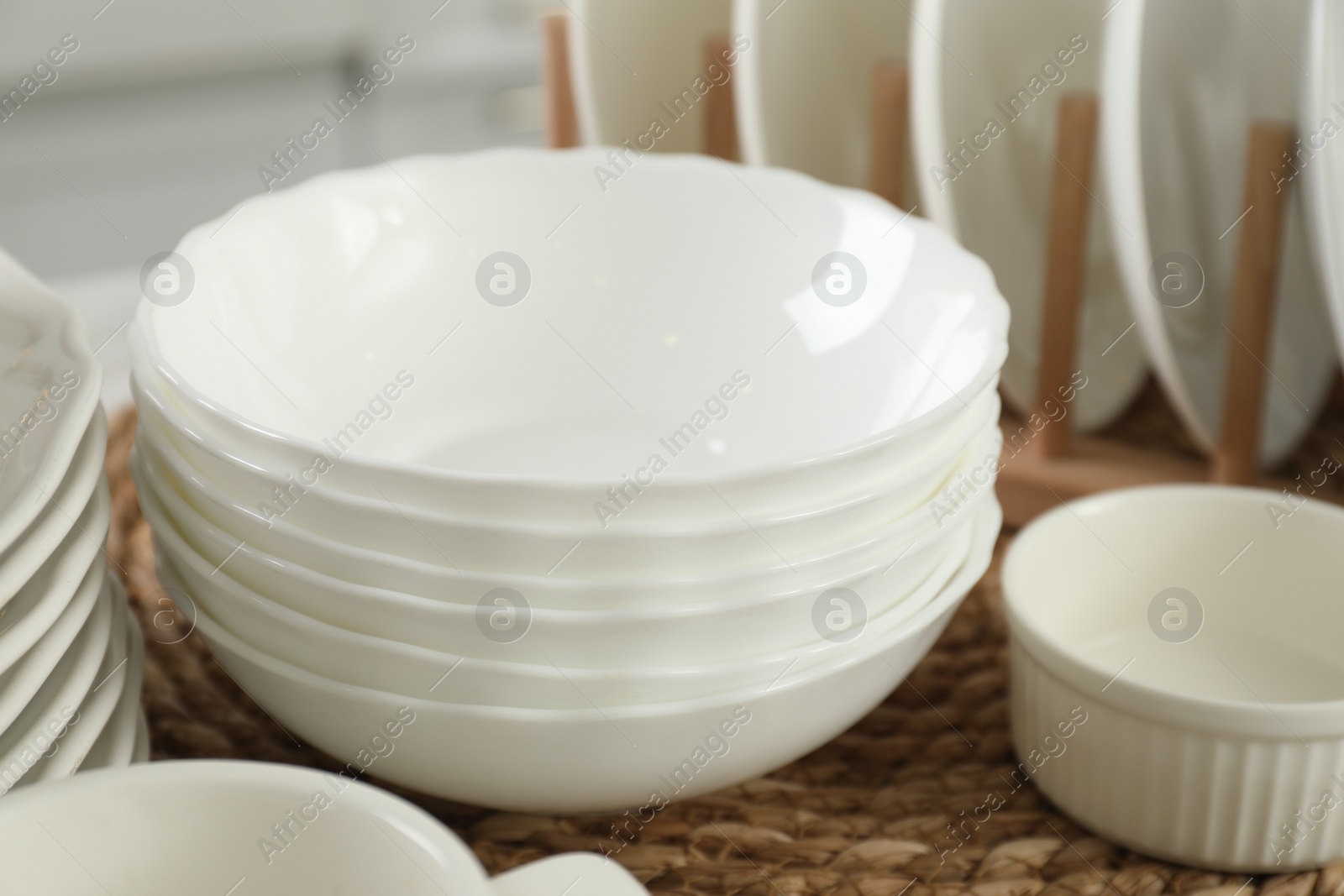 Photo of Clean plates and bowls on table, closeup