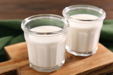 Glasses of tasty milk on table, closeup