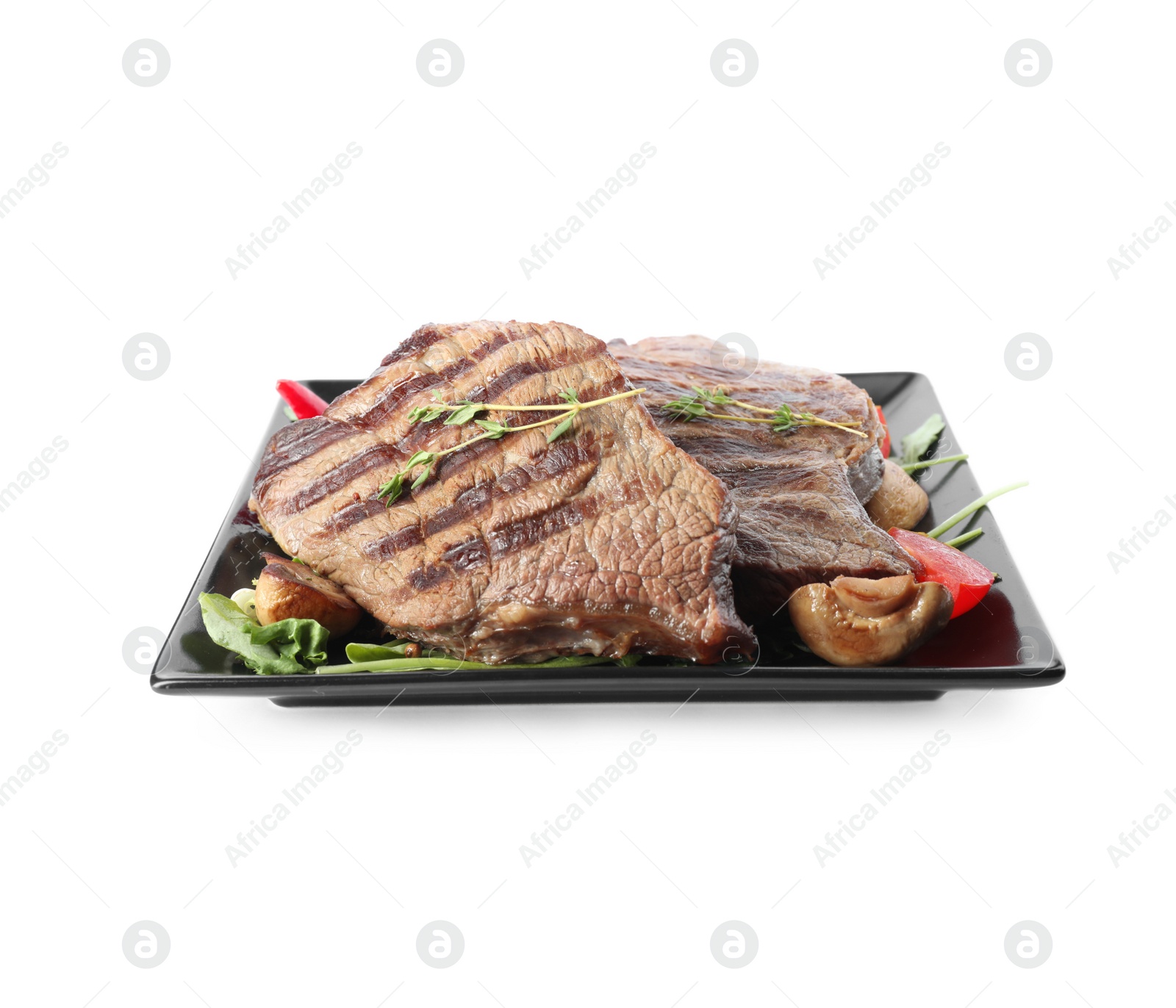 Photo of Plate with delicious beef steaks isolated on white