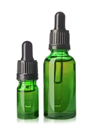 Photo of Cosmetic bottles of essential oils on white background