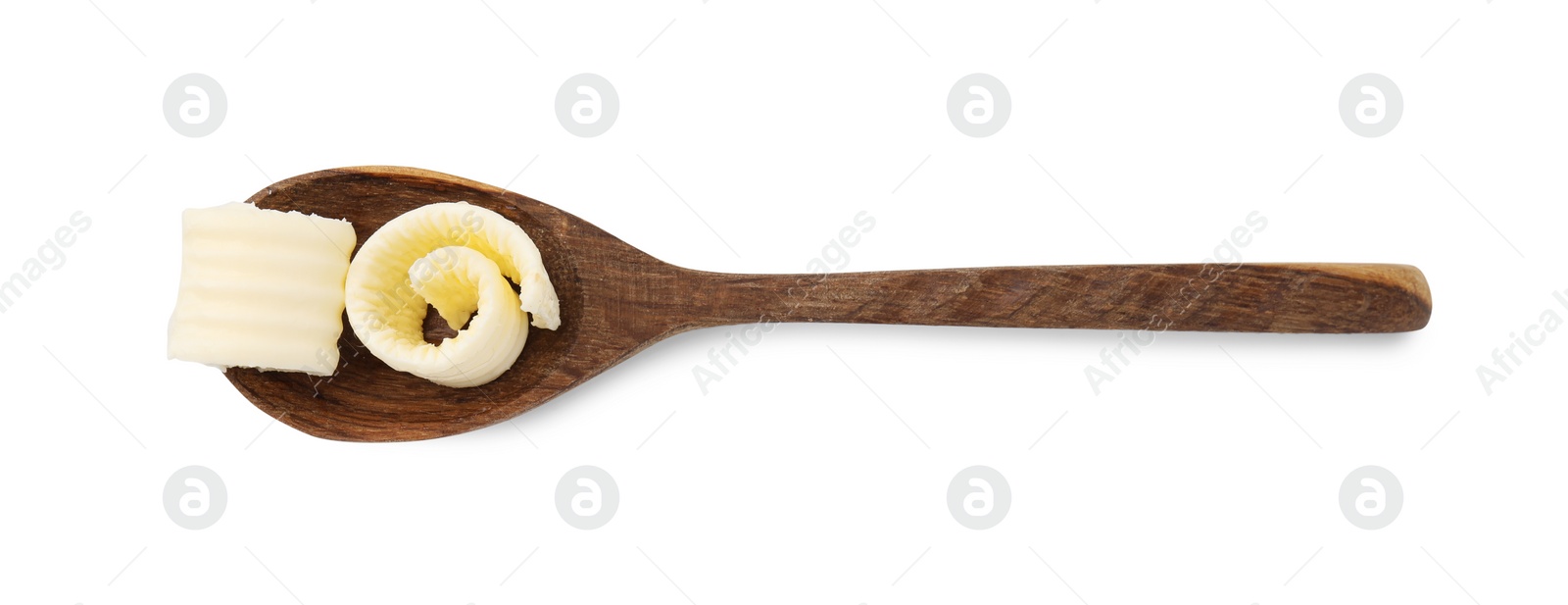 Photo of Tasty butter curls in spoon isolated on white, top view