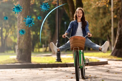 Image of Happy woman riding bicycle outdoors. Strong immunity protecting against viruses