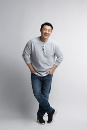 Photo of Full length portrait of happy man on light background