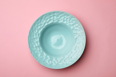 Clean empty plate on color background, top view