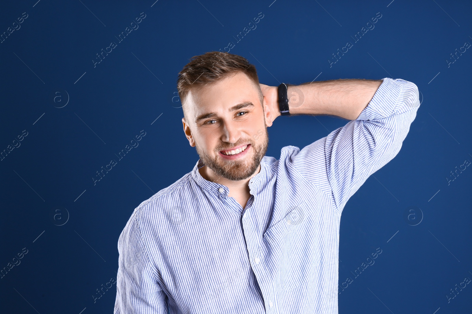 Photo of Portrait of handsome happy man on color background