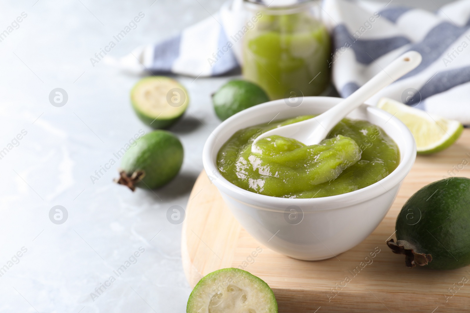 Photo of Feijoa jam on light grey marble table, space for text