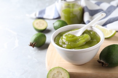 Feijoa jam on light grey marble table, space for text