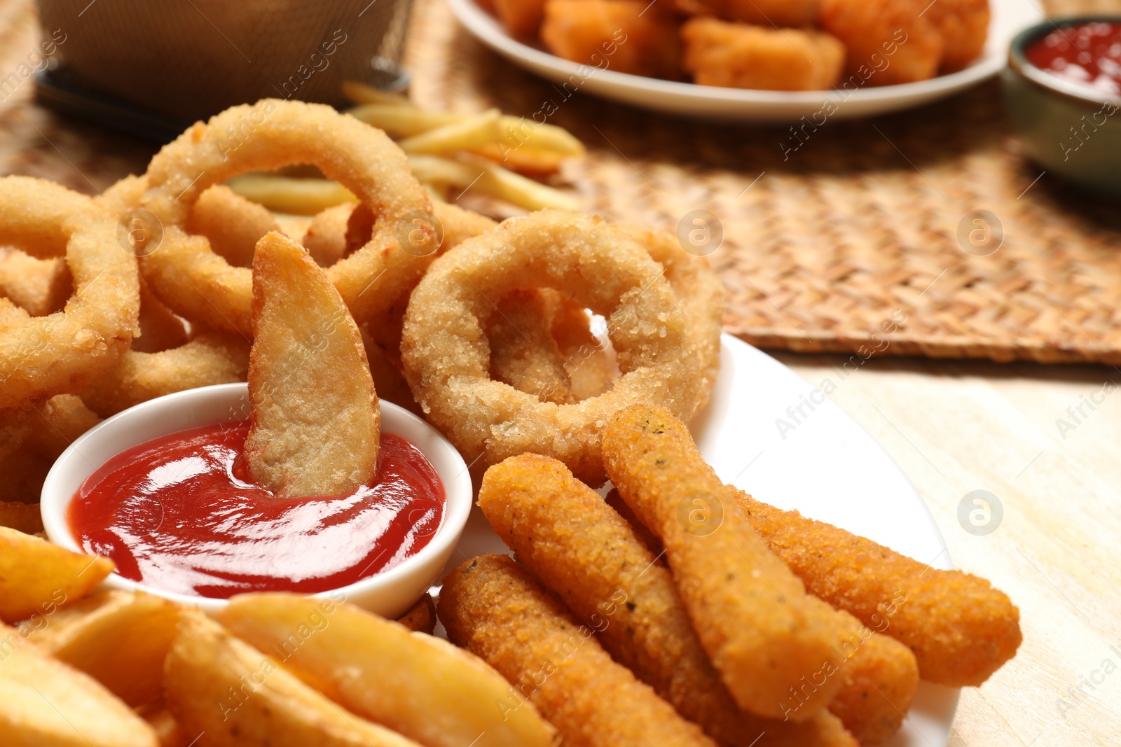 Photo of Different snacks and tasty ketchup on table, closeup