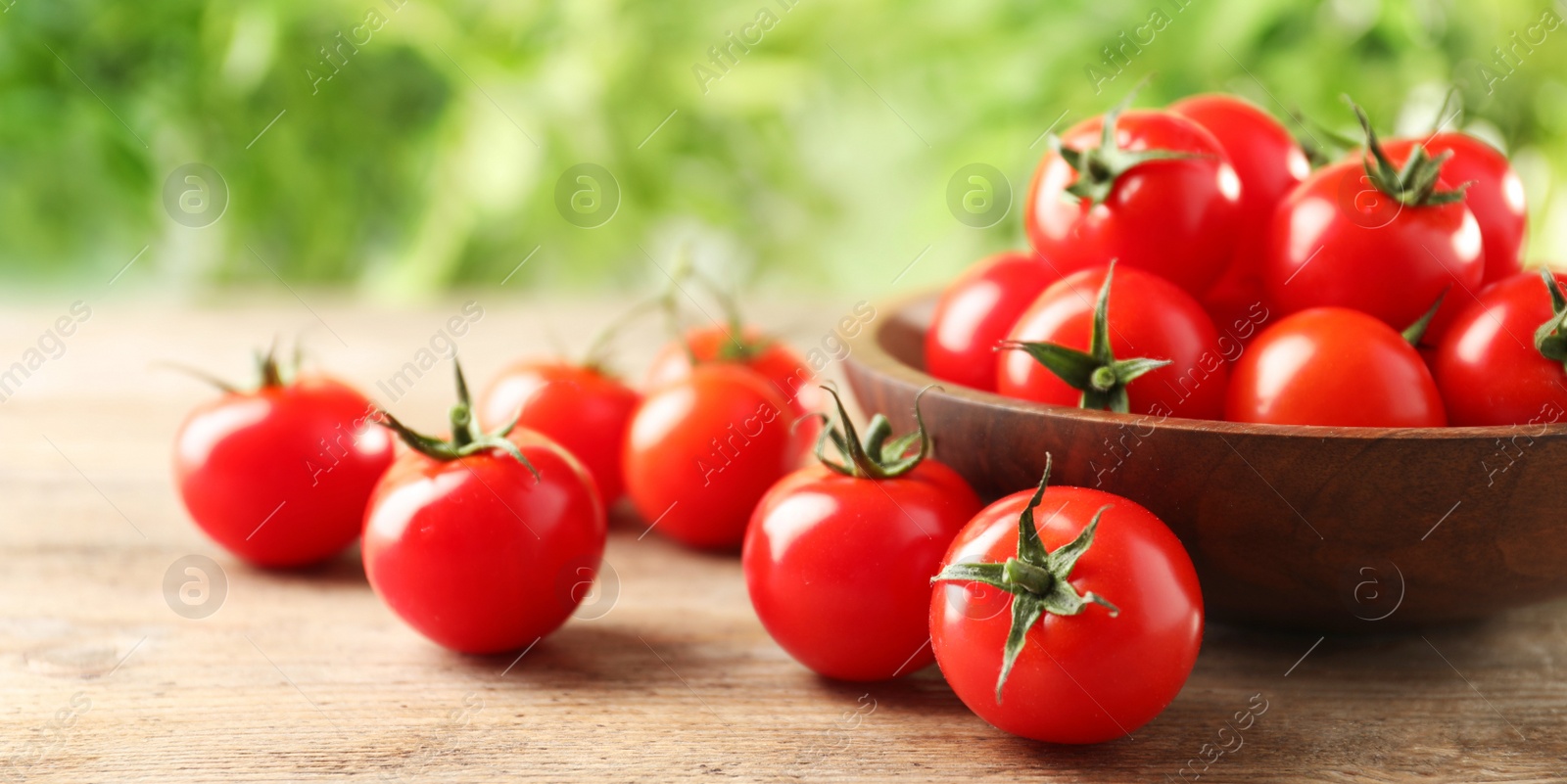 Image of Bowl with fresh tomatoes on wooden table. Banner design 