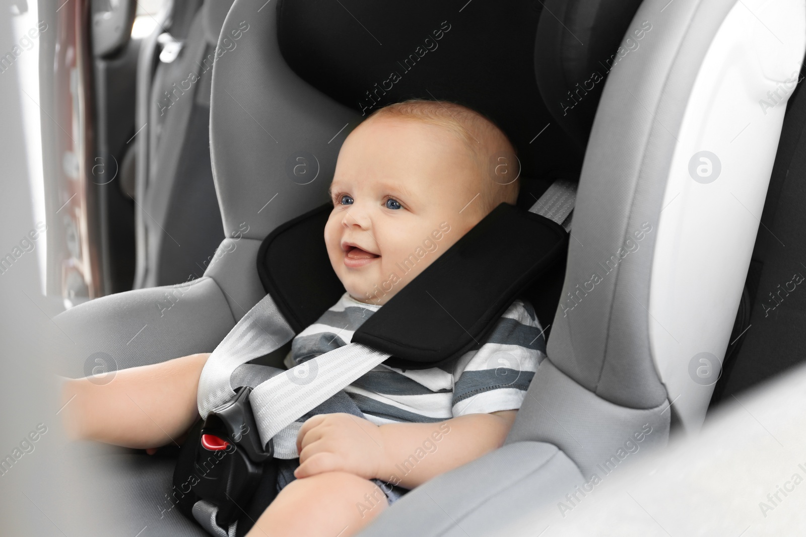 Photo of Little baby in child safety seat inside of car