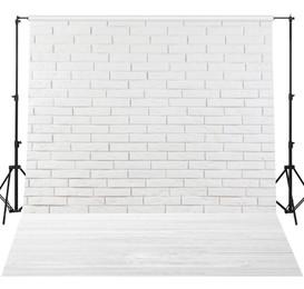 Image of Photo background with white brick wall and wooden floor. Professional studio equipment