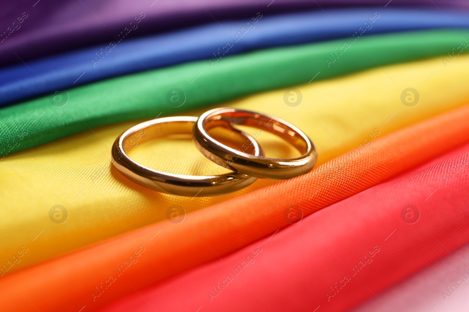 Photo of Wedding rings on rainbow LGBT flag, closeup