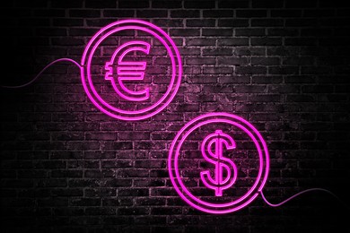 Image of Money exchange neon sign. Magenta euro and dollar symbols on brick wall