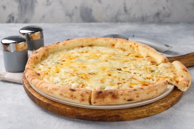 Delicious cheese pizza on light grey textured table