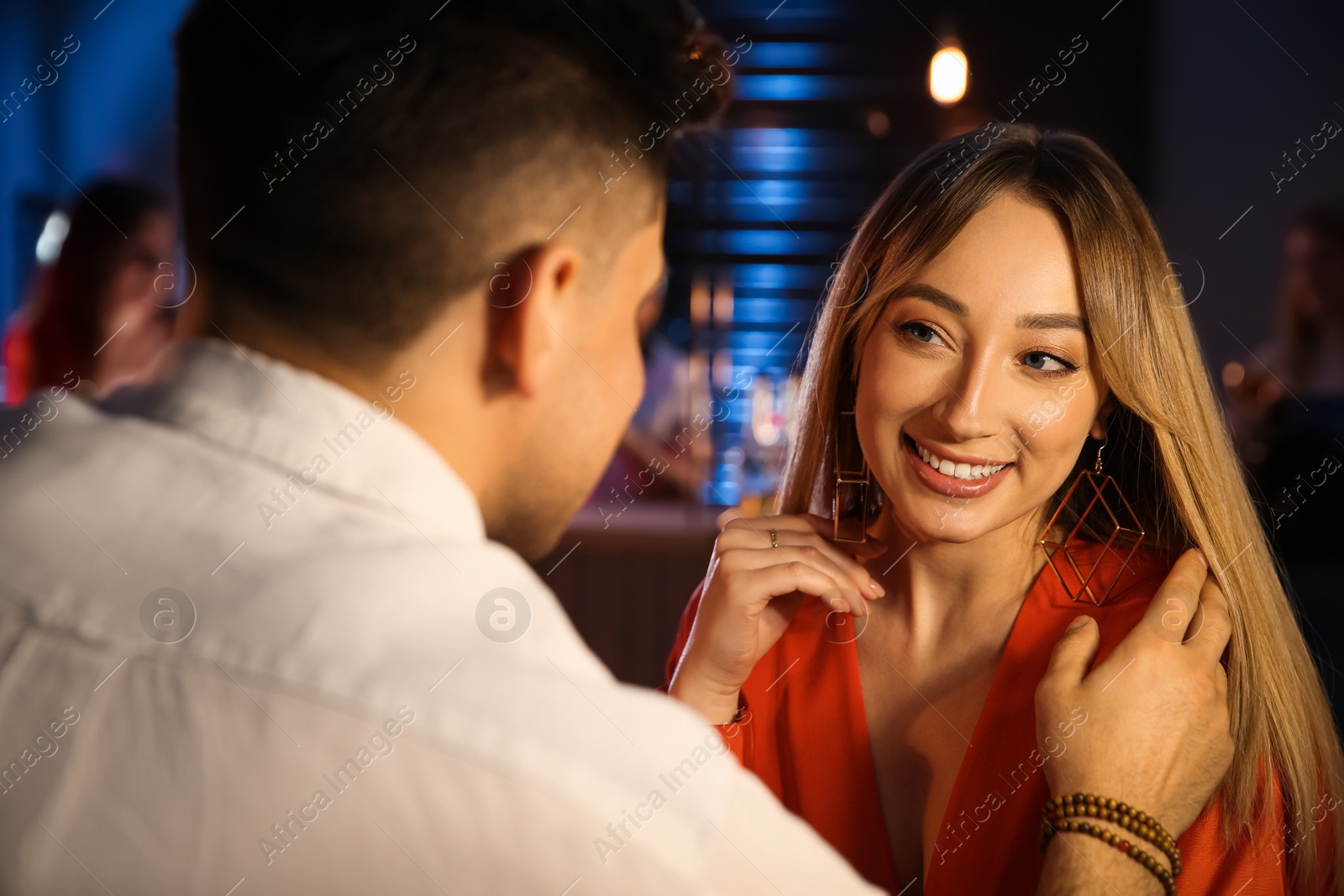 Photo of Man and woman flirting with each other in bar