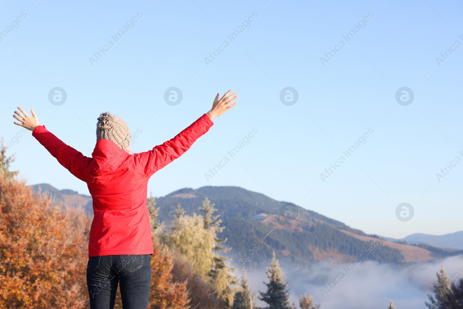 Photo of Woman admiring mountain landscape, back view. Freedom concept