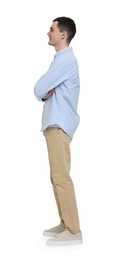 Photo of Young man in light blue shirt and beige pants on white background