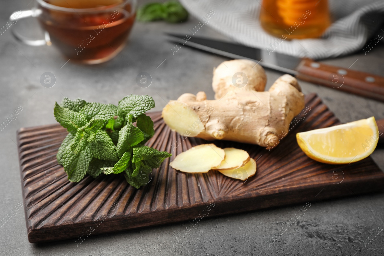 Photo of Wooden board with natural cough remedies on table