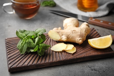 Photo of Wooden board with natural cough remedies on table
