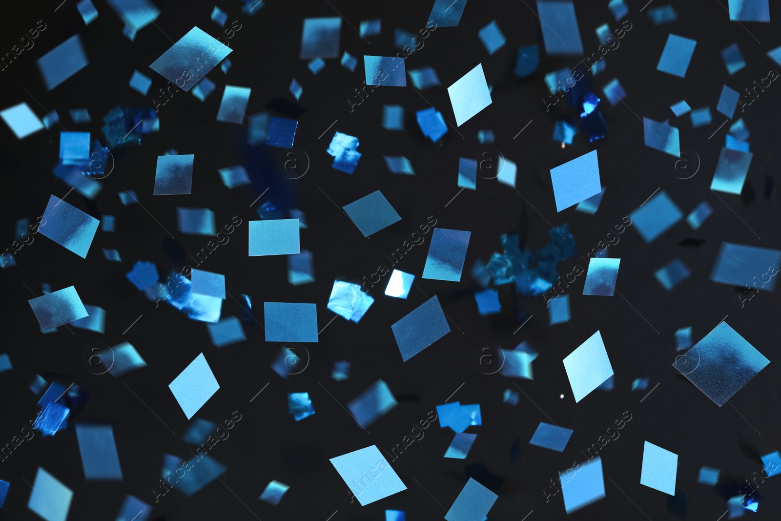 Image of Shiny blue confetti falling down on black background