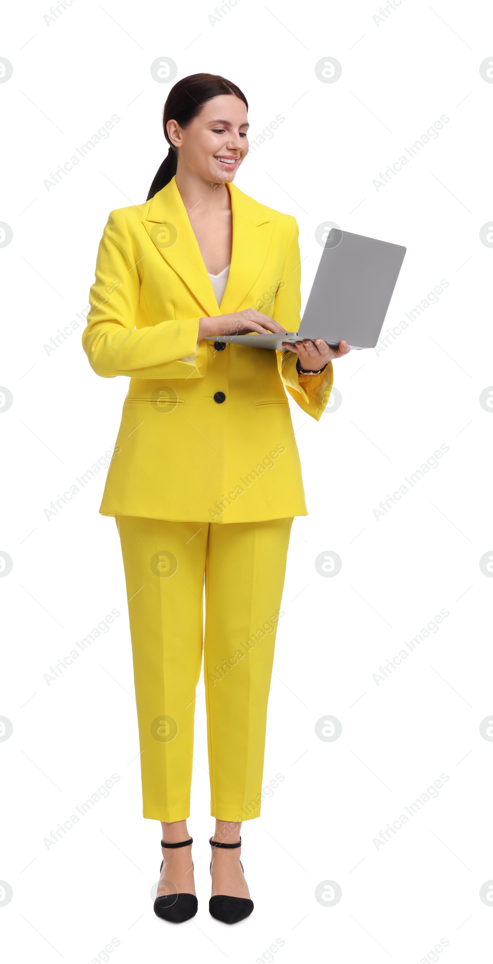 Photo of Beautiful businesswoman in yellow suit with laptop on white background