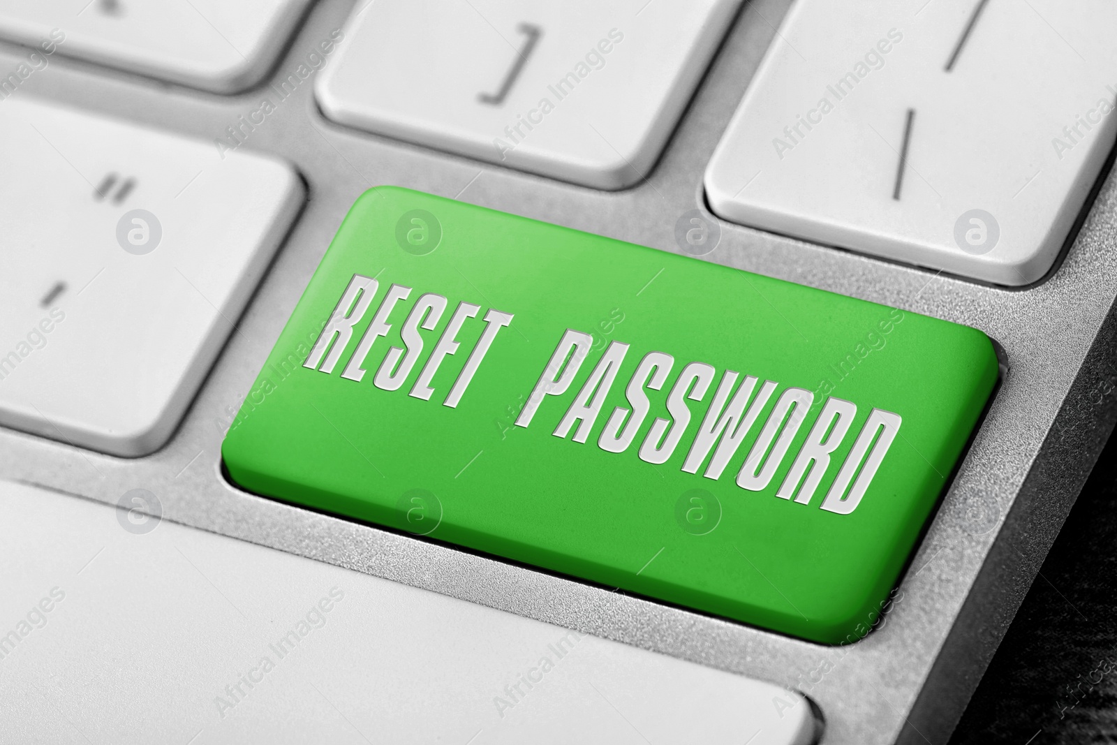 Image of Green button with text RESET PASSWORD on keyboard, closeup view