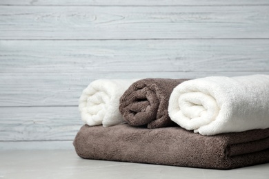 Photo of Fresh towels on table. Space for text