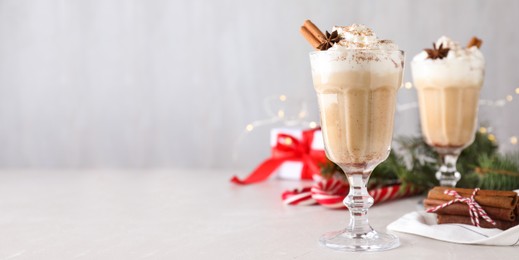 Image of Delicious Christmas cocktail with liqueur on white table, space for text. Banner design