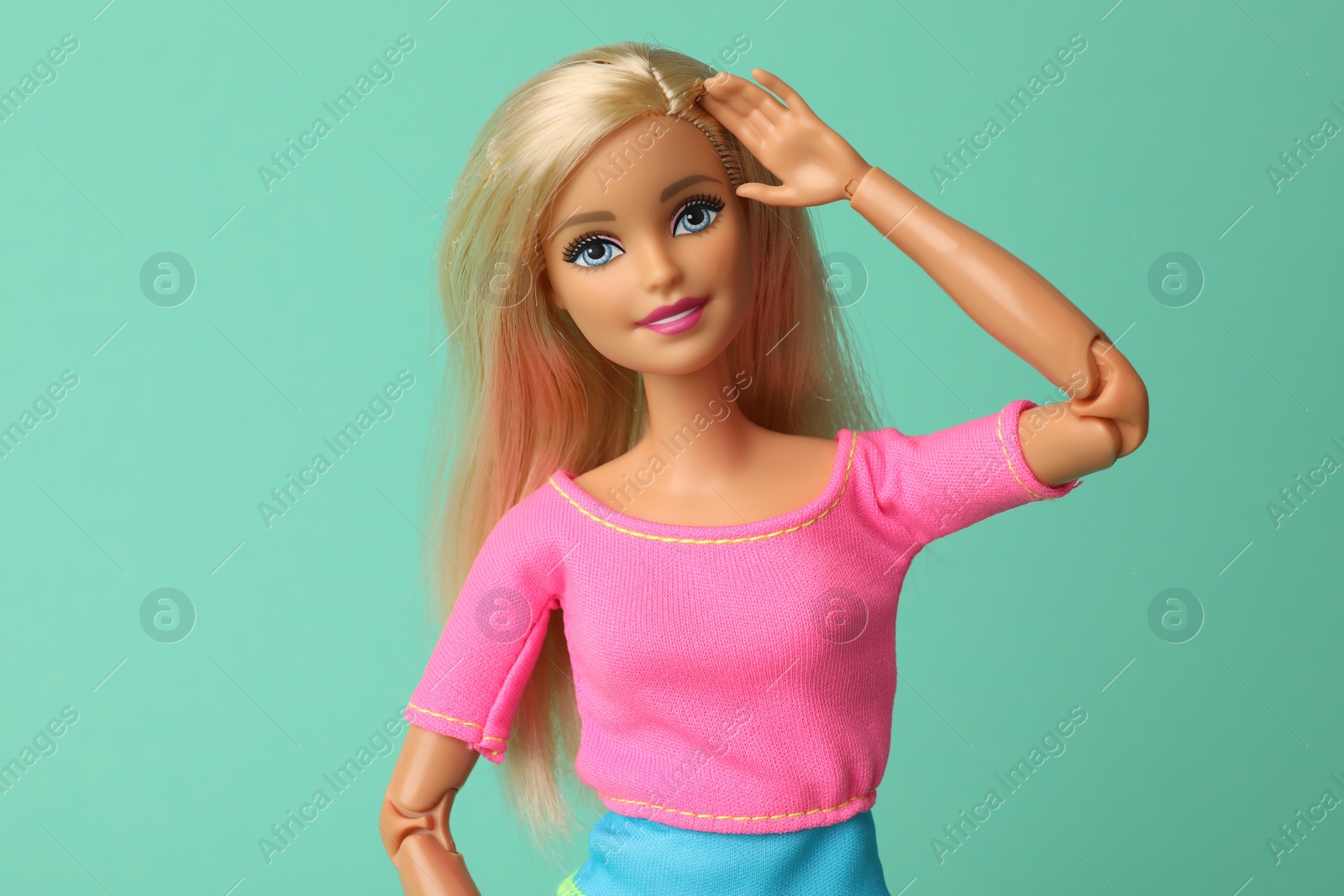 Photo of Mykolaiv, Ukraine - September 2, 2023: Beautiful Barbie doll on turquoise background