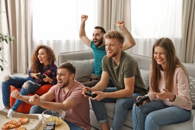 Emotional friends playing video games at home