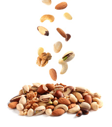 Image of Different nuts falling into pile on white background 