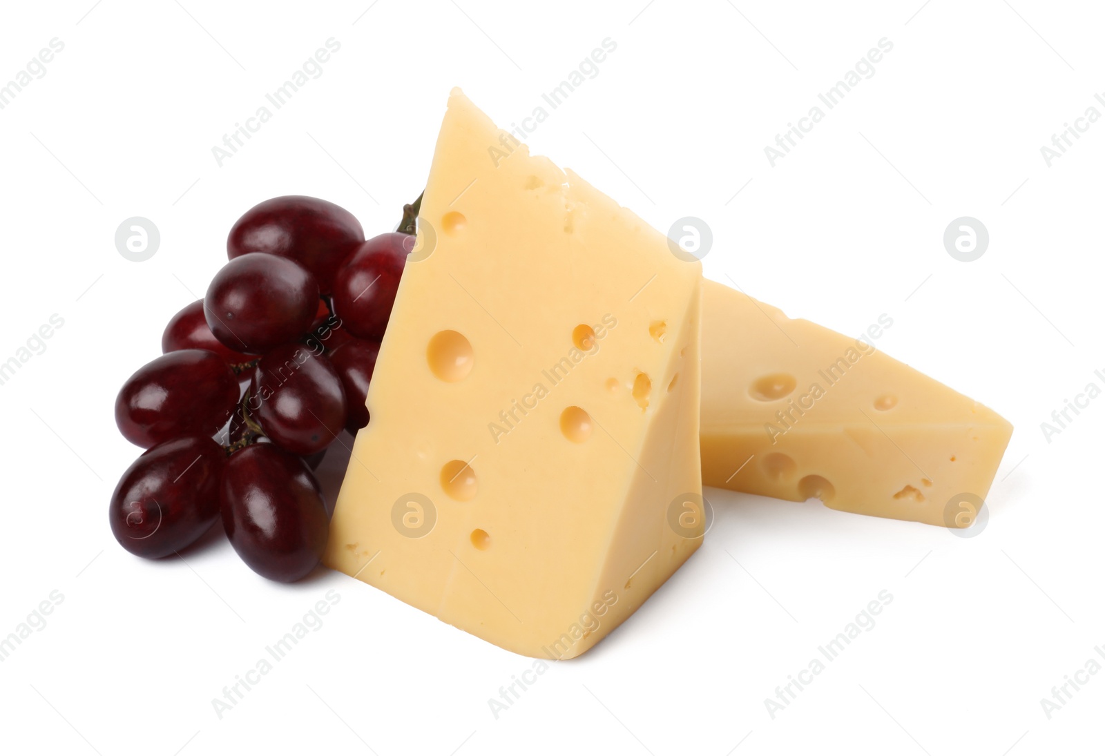 Photo of Pieces of delicious cheese and grapes isolated on white