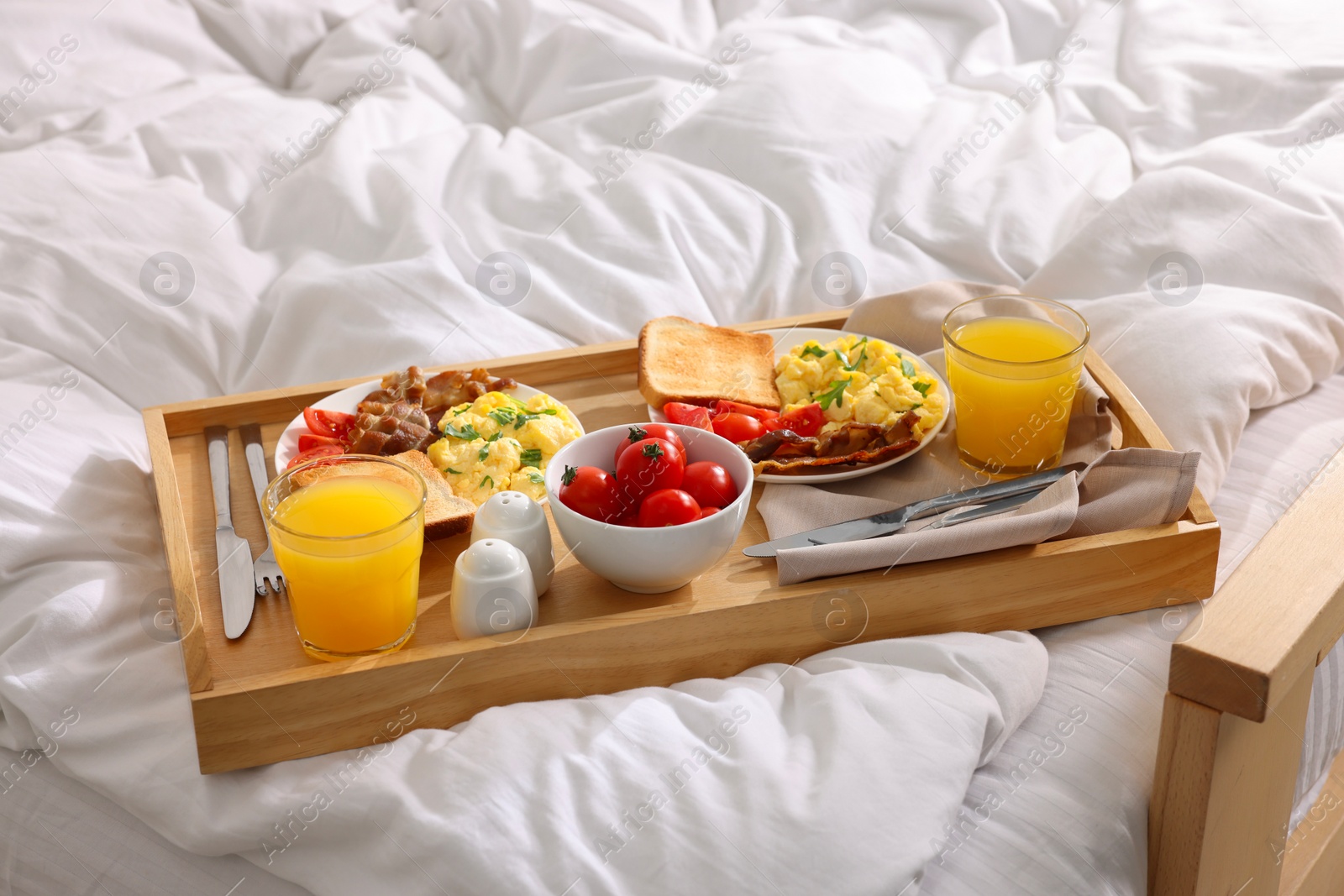 Good morning. Tray with tasty breakfast on bed Photo of Good morning. Tray with tasty breakfast on bed