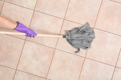 Man cleaning floor with mop, top view