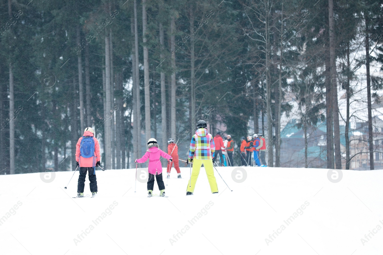 Photo of Skiers on slope at resort. Winter vacation