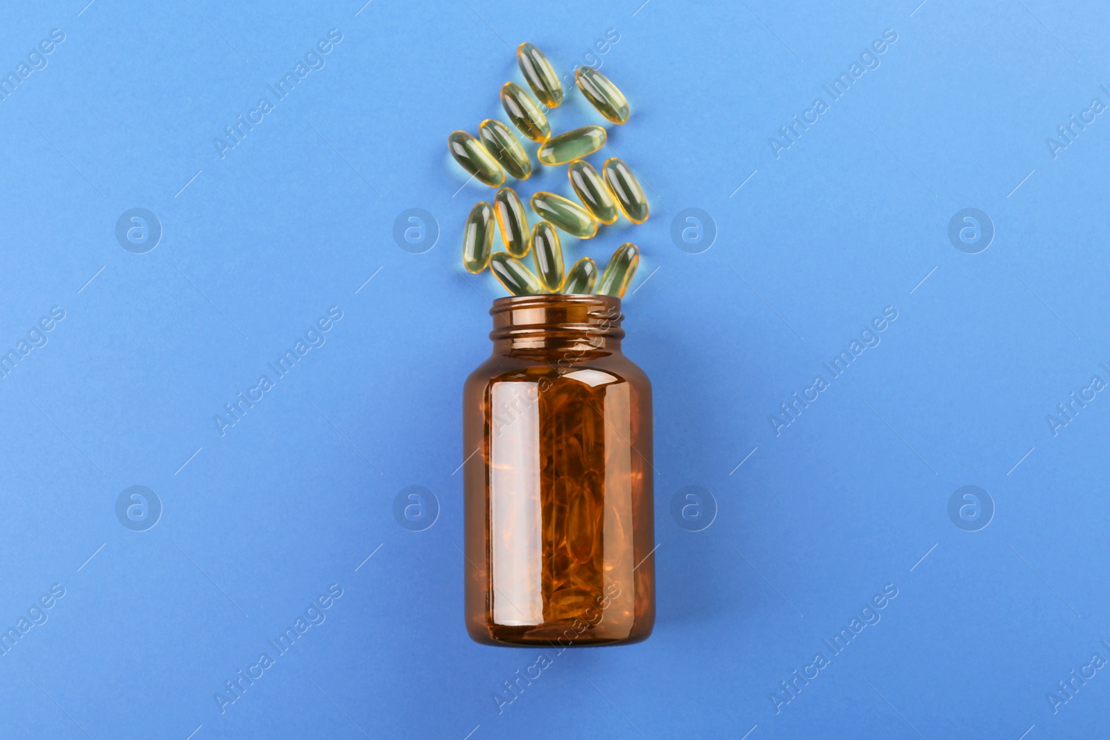 Photo of Jar with vitamin capsules on blue background, top view