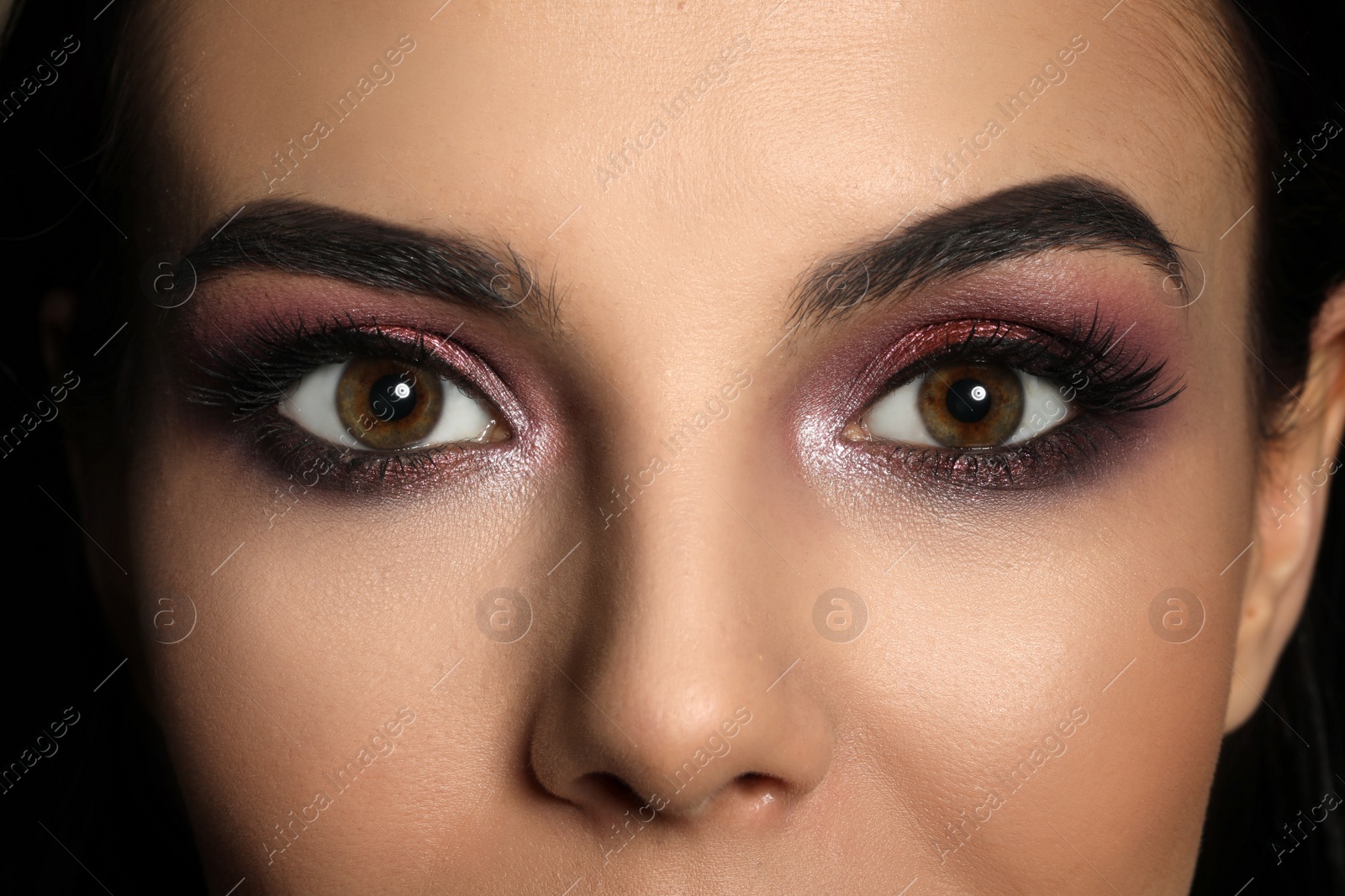 Photo of Young woman with evening makeup, closeup. Eye shadow product