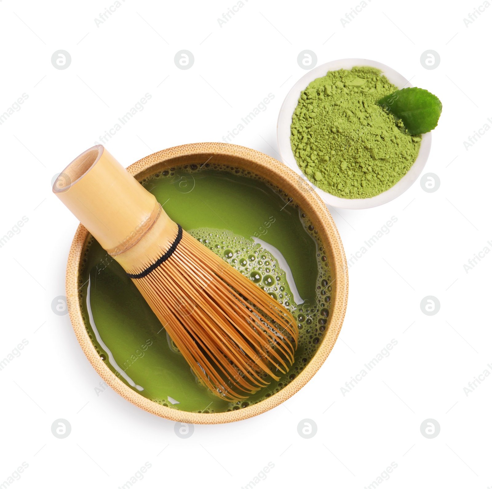 Photo of Bowl of fresh matcha tea with bamboo whisk and powder isolated on white, top view
